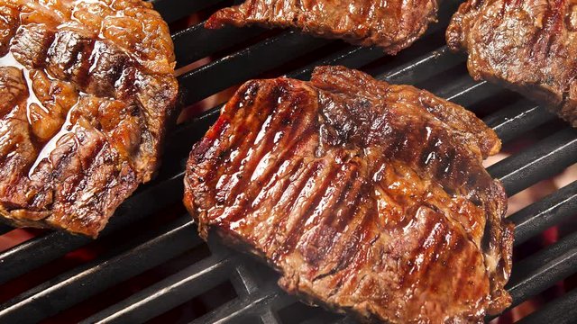 Beef steak on the grill with fire. Brazilian barbecue. Smoke