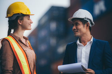 Businessmen, executives and engineers wear medical face masks. While inspecting industrial plants and warehouses for international shipping businesses Concepts of import and export