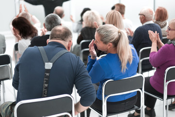 Fototapeta premium Audience of adult people listen to the speech of the lecturer
