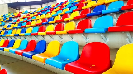 Naklejka premium Benches of different colors in a sports stadium
