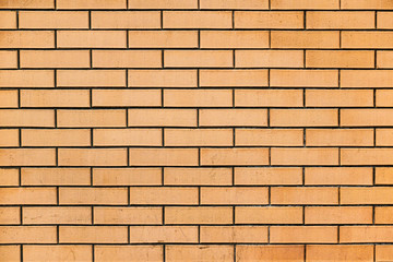 Smooth yellow brick wall. Texture of yellow brick. .The background of the wall is made of yellow brick.