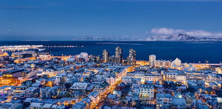 Brightly glowing streets and buildings of Reykjavik city in night time
