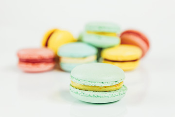 Sweet almond colorful pastel pink blue yellow green macaron or macaroon dessert cake isolated on white background. French sweet cookie. Minimal food bakery concept Copy space