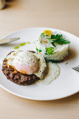 poached egg on steak with rice garnish