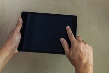 Male hands working on a tablet