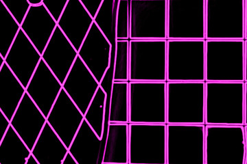 Abstract purple neon texture with the image of lines and geometric shapes on a black background.