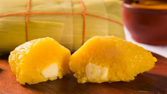 Slide shot Pamonha with cheese - typical food of green corn - tasty and cheap - typical and popular street food with smoke.