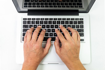 Male hands typing on a laptop