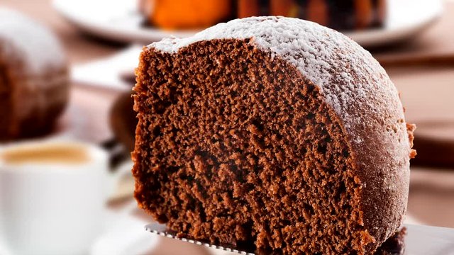 Slide shot Chocolate cake on the table with carrot cake in the background.