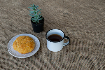 corn cake on plate with blue border and white mug and small plant on jute towel