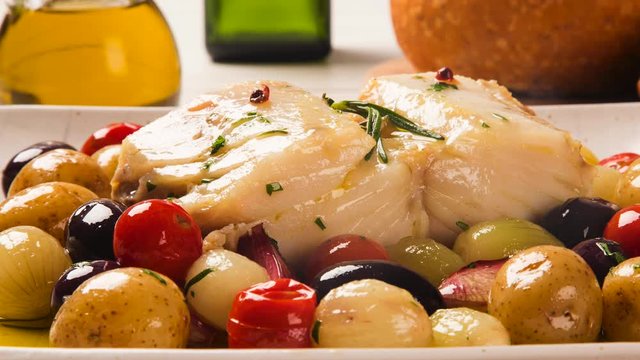 Slide shot codfish on the plate with smoke. Top View.