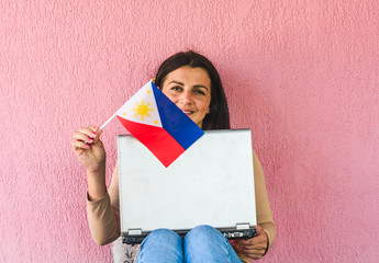 woman with laptop computer and flag of  Philippines