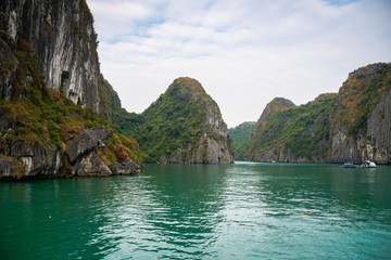Obraz na płótnie Canvas Halong Bay, Vietnam, with limestone hills. Dramatic landscape of Ha Long bay, a UNESCO world heritage site and a popular tourist destination.