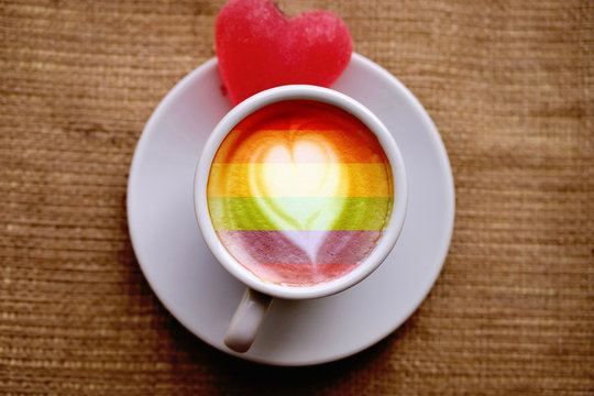 one white cup with coffee and marmalade heart stands on a windowsill on burlap fabric, loneliness. LGBT natural pattern, Vintage texture background, Abstract painting