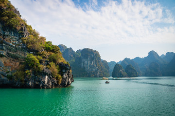 Naklejka na ściany i meble Halong Bay, Vietnam, with limestone hills. Dramatic landscape of Ha Long bay, a UNESCO world heritage site and a popular tourist destination.