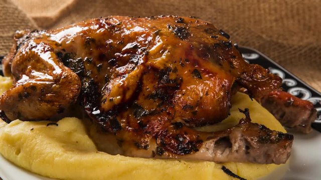 Little Chicken dish with polenta on wood background. Top view with smoke.
