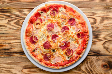 Delicious italian pizza served on wooden table