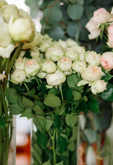 Fresh blooming flowers in a flower shop (roses, peonies)
