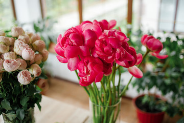 Bouquet of pink peonies in a flower hall. Floral set of fresh flowers.