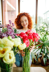 Florist at work: female florist making beautiful bouquet in shop