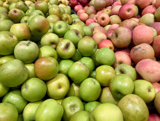 Close-up green, red apples in a supermarket, food and retail concept