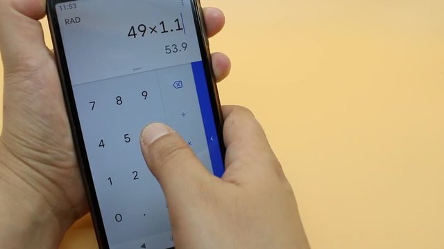 Person who calculates VAT on his cell phone