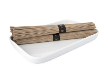 Double soba noodles, buckwheat noodles on white plate, on white background

