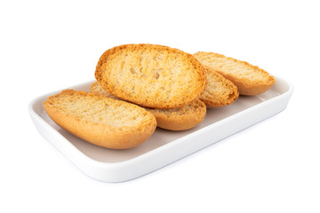 Crispy biscottes, french toast bread on white plate, on white background
