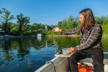 Fototapeta premium Fish feeding from boat in lake corner