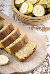 vegan banana bread, with banana slices on the side, on a white table. Healthy vegan life concept.