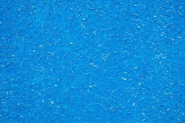 Fototapeta na wymiar texture of pressed sawdust. Particleboard is painted in blue.