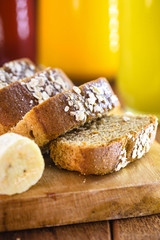 Sliced ​​vegan bread, gluten-free and without animal products. Vegetarian bread with oatmeal, banana flavor, on a rustic white table, sliced ​​and ready to serve.