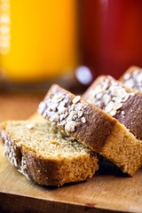 Sliced ​​vegan bread, gluten-free and without animal products. Vegetarian bread with oatmeal, banana flavor, on a rustic white table, sliced ​​and ready to serve.