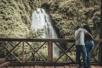 young couple on the bridge (waterfall)