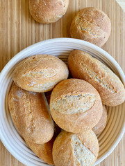 Homemade bread from whole wheat flour on a wooden table. Daylight, indoors, close-up, this is a good option for a healthy breakfast or snack. Healthy food