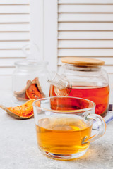 Bael fruit juice or quince tea and dried bael sliced fruit on light gray background. Thai or Asian healthy drink. Bael is helping the body to resist catching a cold