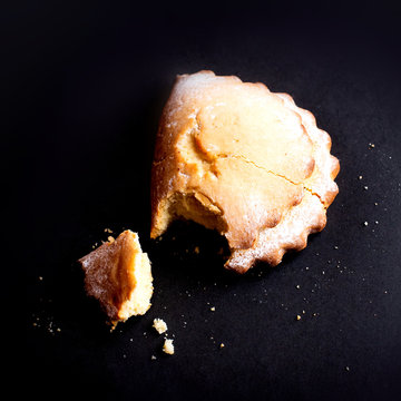 Sweet USSR soviet Russian nostalgic cottage cheese curd shortbread bun cookie Socknik. Pastry on dark grey black background. For thematic websites, magazine or food blog recipes, bakery advertising