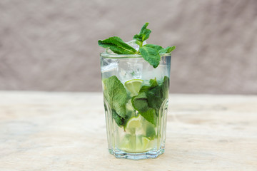 Lemonade with mint and ice cubes. A fresh summer non alcoholic fruit and citrus cocktail.