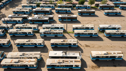 Fototapeta premium Many trolleybuses parked in front of the trolley depot hangar. Social transport. Vinnytsia, Ukraine, 2020