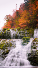 Beautiful scenery of cascading waterfalls with stunning autumn fall foliage colors. Egypt Falls, Cape Breton, Nova Scotia, Canada