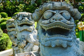 A cute tiny lions statues with Chinese style located in a Thai temple, Wat Arun, Bangkok, Thailand