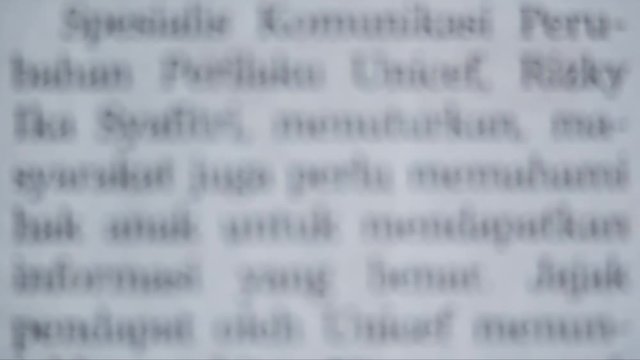 Close up of blurred newspaper scrolling upward