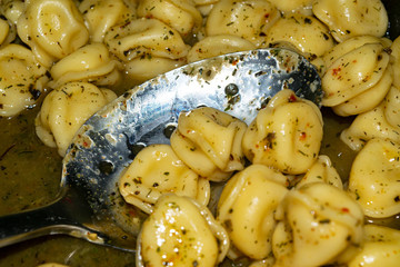 Small dumplings are cooked in a pan with spices. Close up.