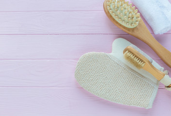 Close up wooden massage brushes for skin and body care on pink background. Beauty, spa and bath concept.  Flat lay, top view