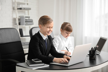 Fototapeta premium Little secretaries working in office