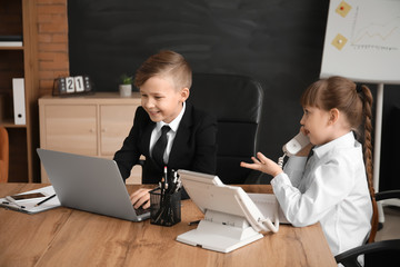 Little secretaries working in office