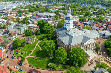 Fototapeta na wymiar Aerial view of Maryland State House capitol building white dome and state circle with colonial houses in Annapolis on a sunny weekend afternoon 
