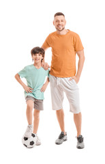 Father and little son with soccer ball on white background