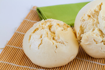 Chinese Steamed Buns Mantou on a bamboo mat close up