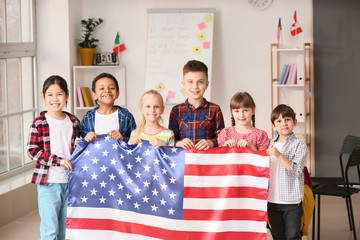 Little children with flag of USA at language school